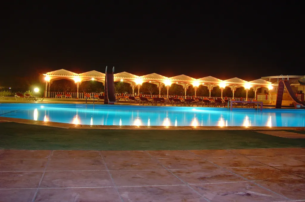 Resort pool glowing at night, a festive scene on all inclusive New Year holidays in Egypt