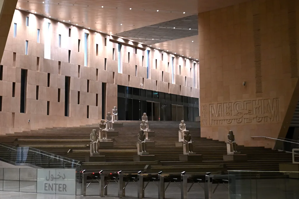 Illuminated hall of the Grand Egyptian Museum with royal statues, a highlight of an All Saints' Day holiday in Egypt