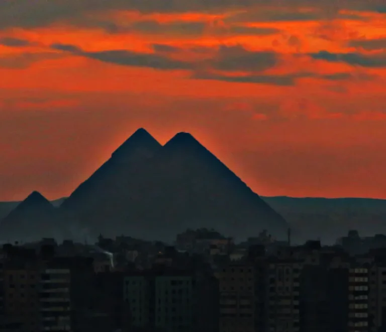 Cairo or Luxor: the Giza pyramids rising above the Cairo skyline at sunset
