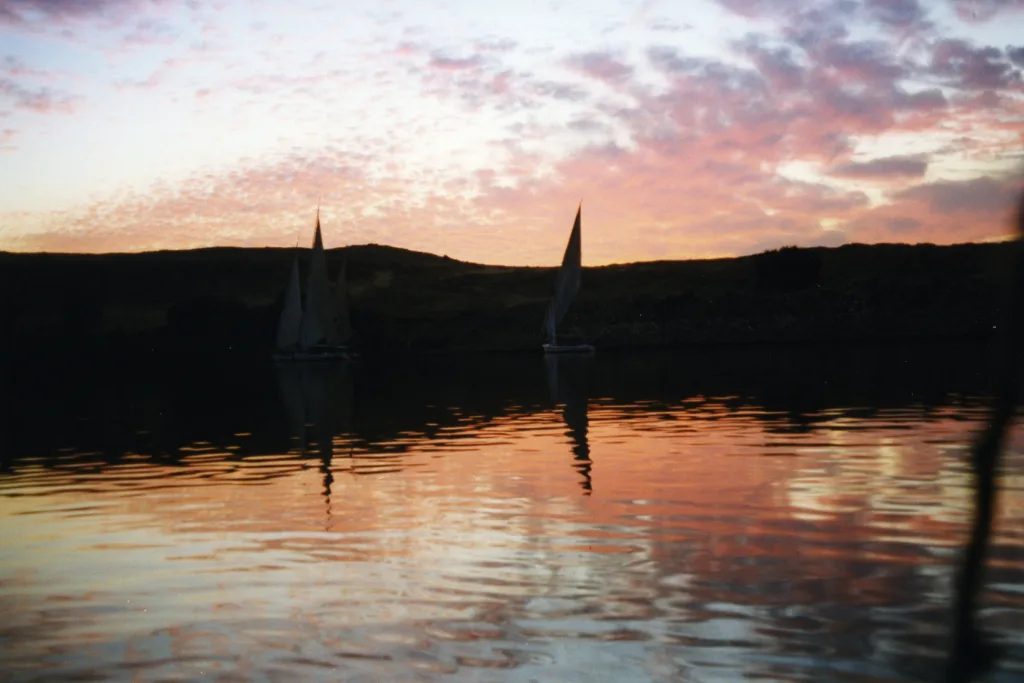 Felucca silhouette at sunset, a cheap Christmas getaway idea in Aswan - cheap christmas vacations