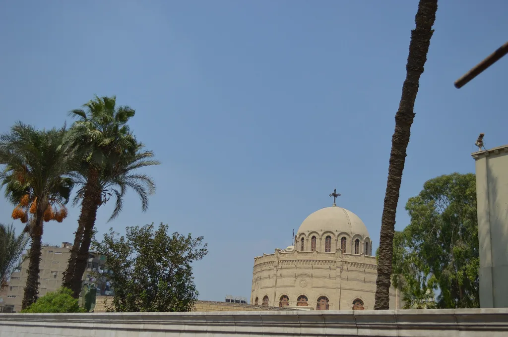Church dome among palms in Coptic Cairo, a peaceful stop during cairo at christmas