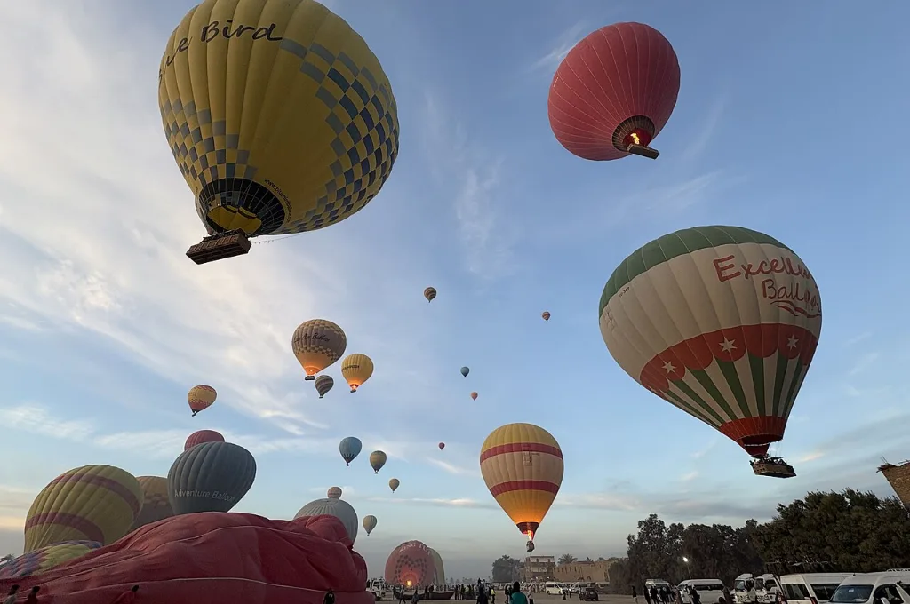 Romantic hot air balloon rides over Luxor farmland at sunrise