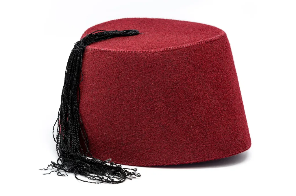 Egyptian traditional clothes: a red felt tarboosh with a black tassel