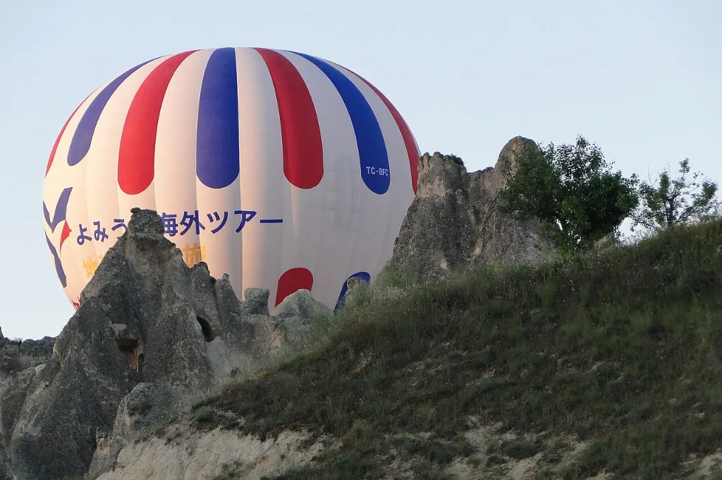 Turkish hot air balloon rising at dawn near Goreme