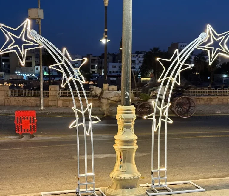 Romantic Christmas getaways in Egypt: festive star lights on the Luxor Nile Corniche at dusk