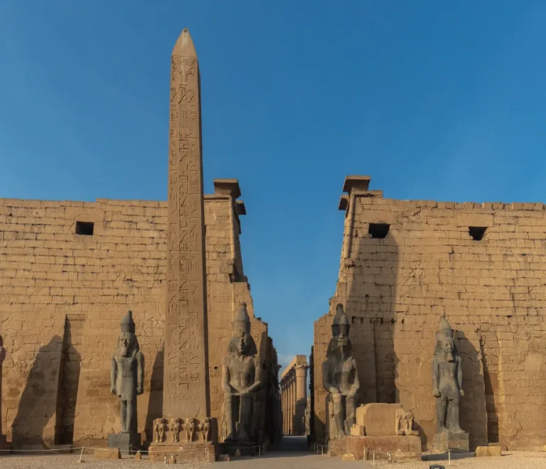 things to do in Luxor, Pylon, obelisk and colossi at the entrance of Luxor Temple, Egypt