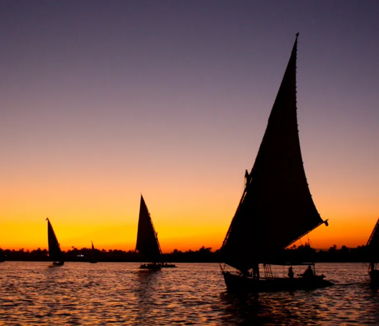 Sunrise over the Nile at Luxor with feluccas silhouetted against the glowing sky, what is the weather in Luxor