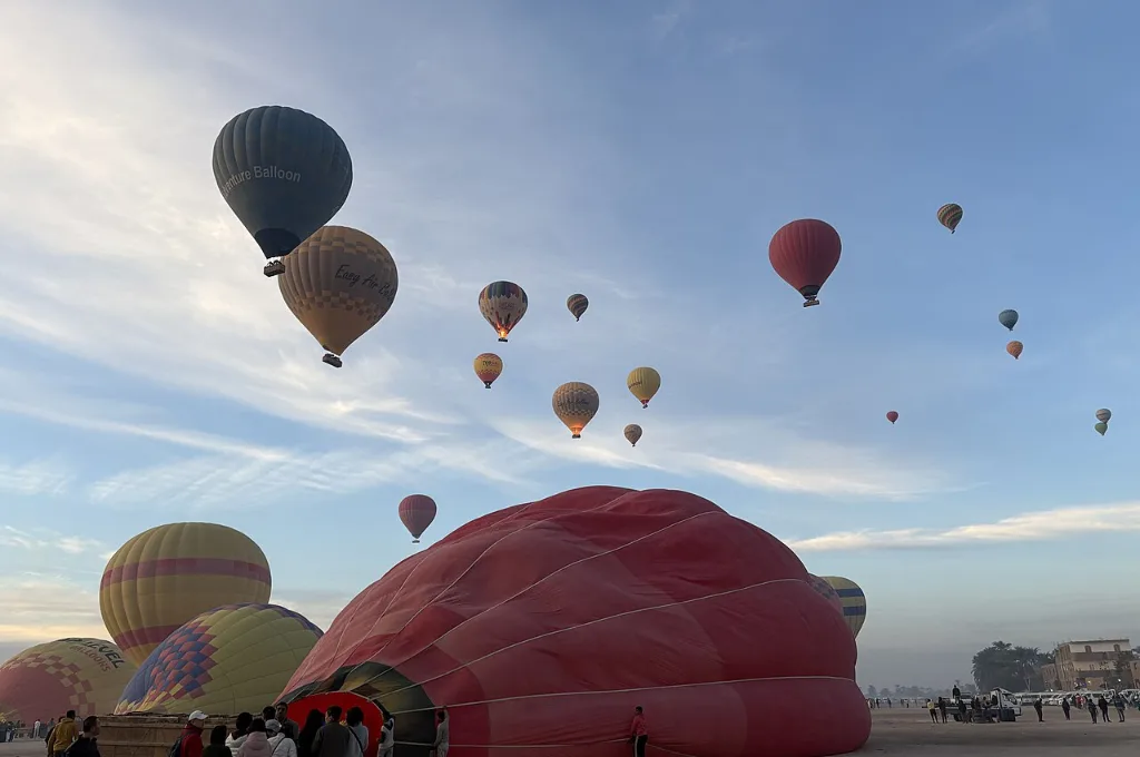 Sunrise hot air balloon ride over Nile farmland near Luxor