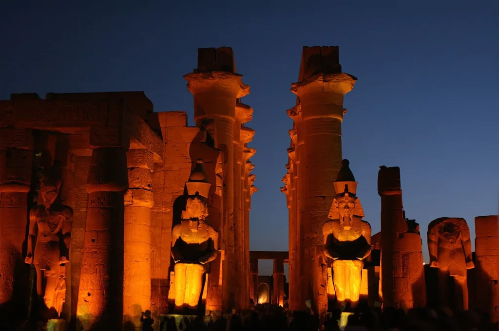 Luxor Temple colossi and columns floodlit at night, a highlight of romantic Christmas getaways