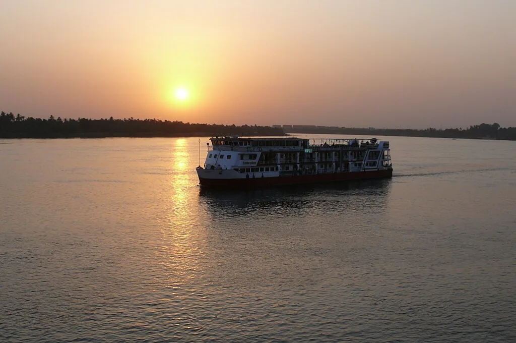 Nile cruise ship sailing into the sunset near Kom Ombo on romantic Christmas getaways