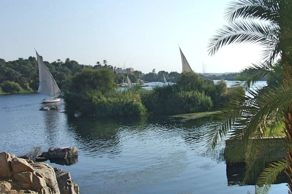 Felucca sails beside Elephantine Island, a sunny setting for warm Christmas vacations in Aswan