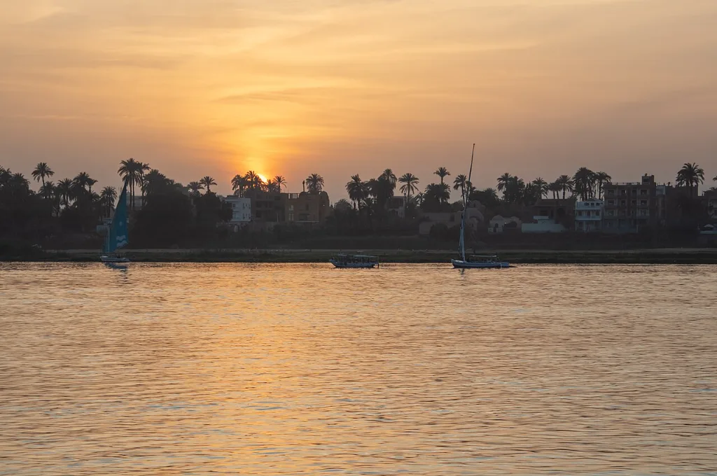 Sun setting over the Nile at Luxor with feluccas, an evening highlight of warm Christmas vacations