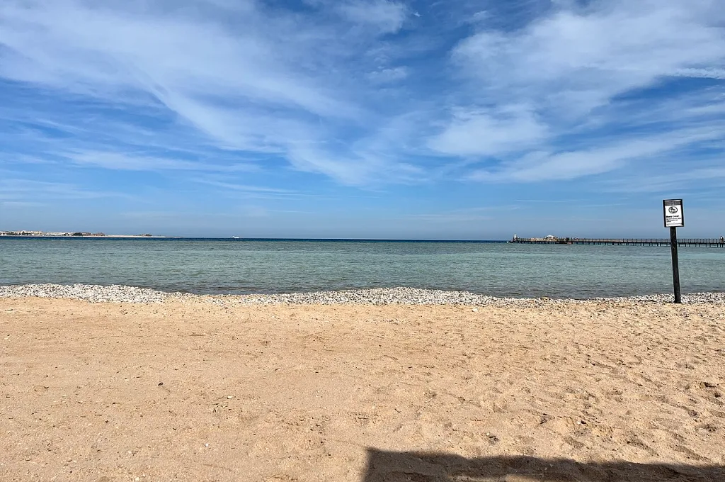 Empty sandy Red Sea beach at Sahl Hasheesh under blue sky, ideal for warm Christmas vacations